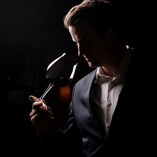 A man smelling a wine glass at the Dans le Noir ? restaurant