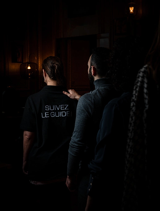 Guests walking in single file on their way to an immersive birthday party at the restaurant Dans le Noir ?